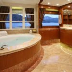 Large marble bathroom and wood paneling