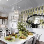 For a snow-white kitchen with many elements of the Art Nouveau style, the implementation of the accent wall using three-color wallpapers has become the focus of attention