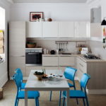 Blue chairs in a gray kitchen