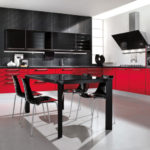 The combination of red and black colors in the design of the kitchen