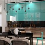 Black dining table in the kitchen with glossy facades