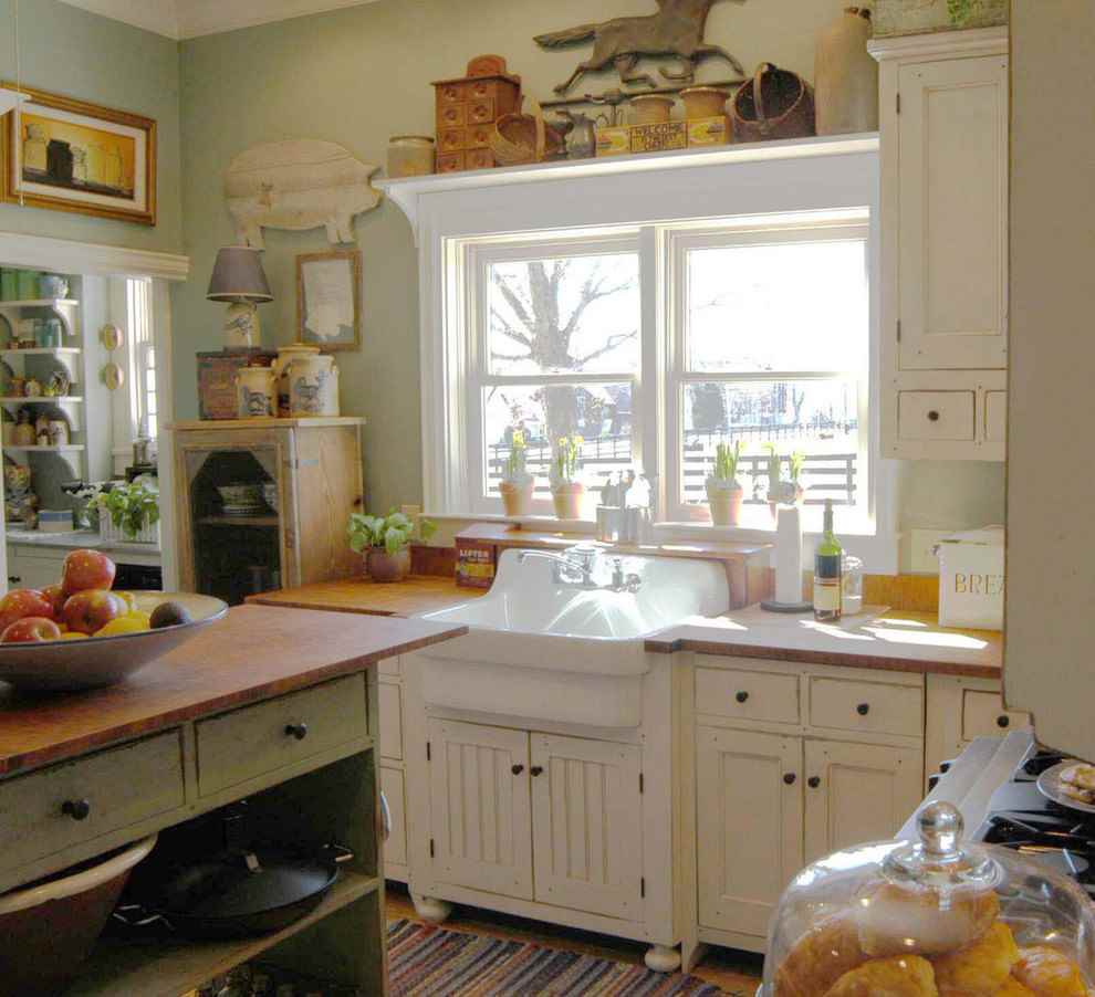 White sink under a rustic kitchen window