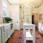 Sink along a large window in a provence style kitchen