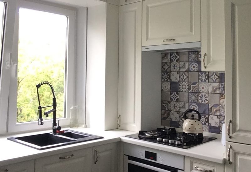 A sink instead of a window sill in a small area kitchen