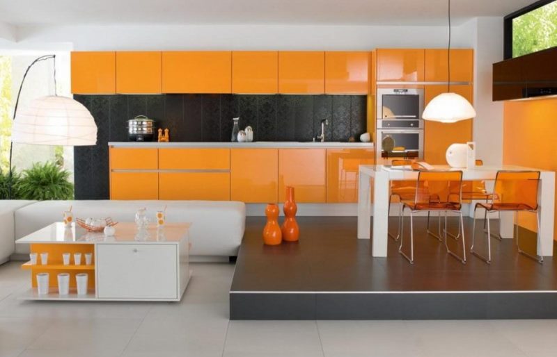 Bright orange kitchen with dining area