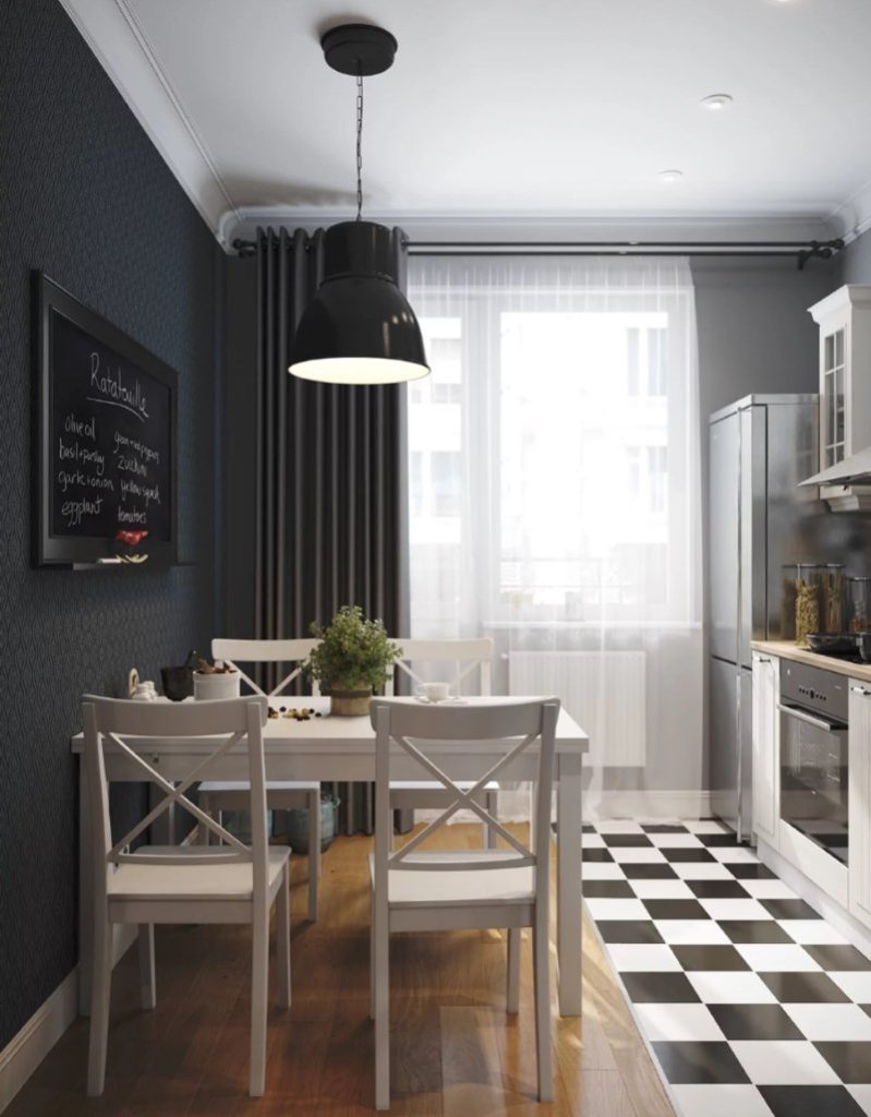 Table à manger lumineuse devant un mur noir dans une cuisine de 8 carrés