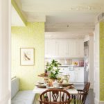 Bright, summer wallpaper pattern used in the decoration of the snow-white kitchen combined with the dining room