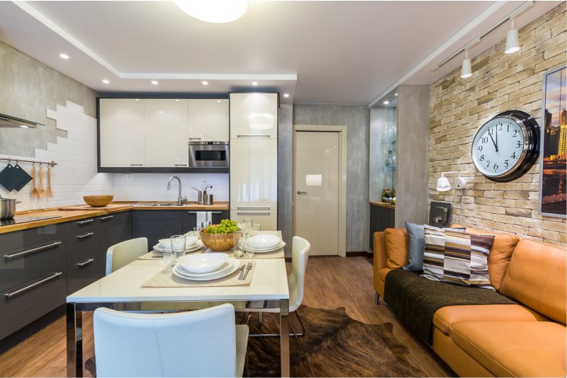 Clock on the wall of the kitchen-living room of a city apartment