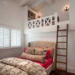 Wooden staircase to the second tier of a small bedroom