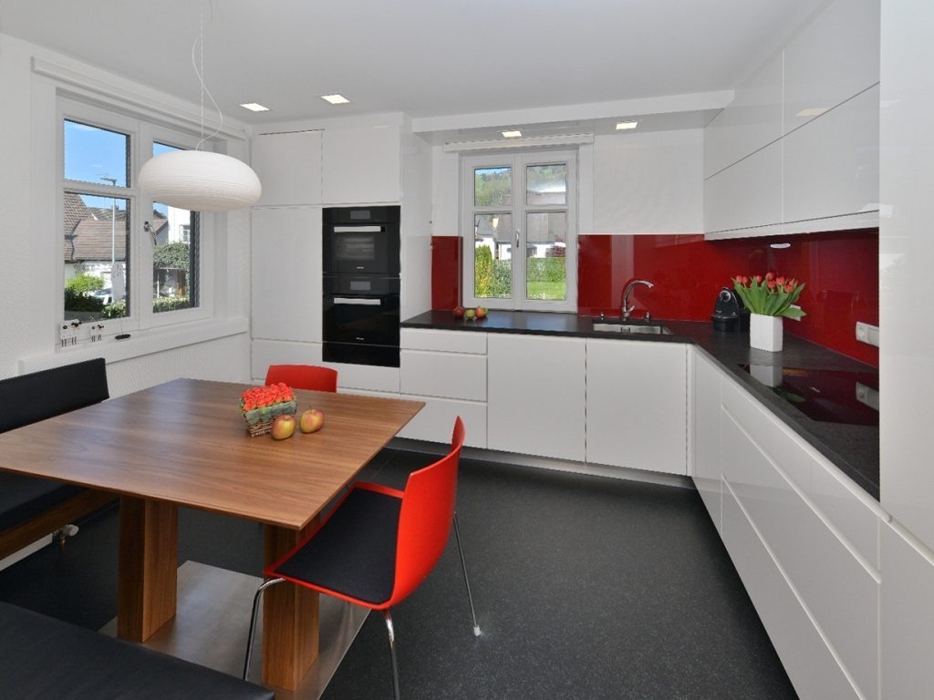 Red plastic chairs in a modern kitchen