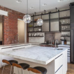 Sink in the kitchen island with marble countertops