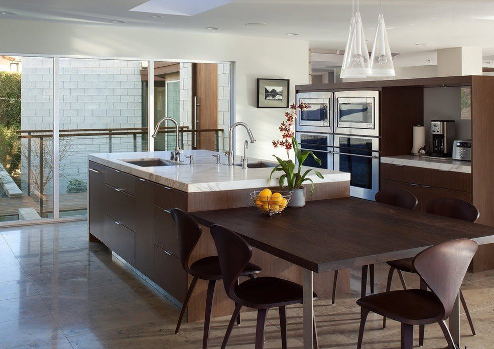 Square dining table near the kitchen island