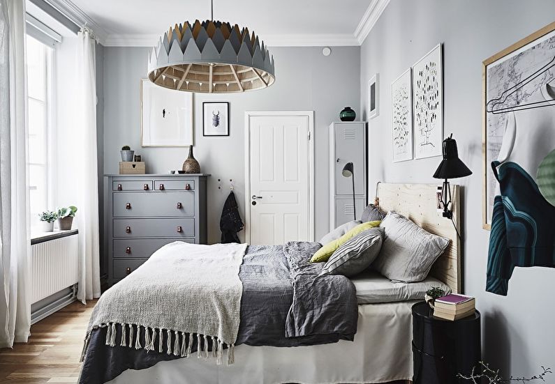 Wooden chandelier above the bed in a small bedroom