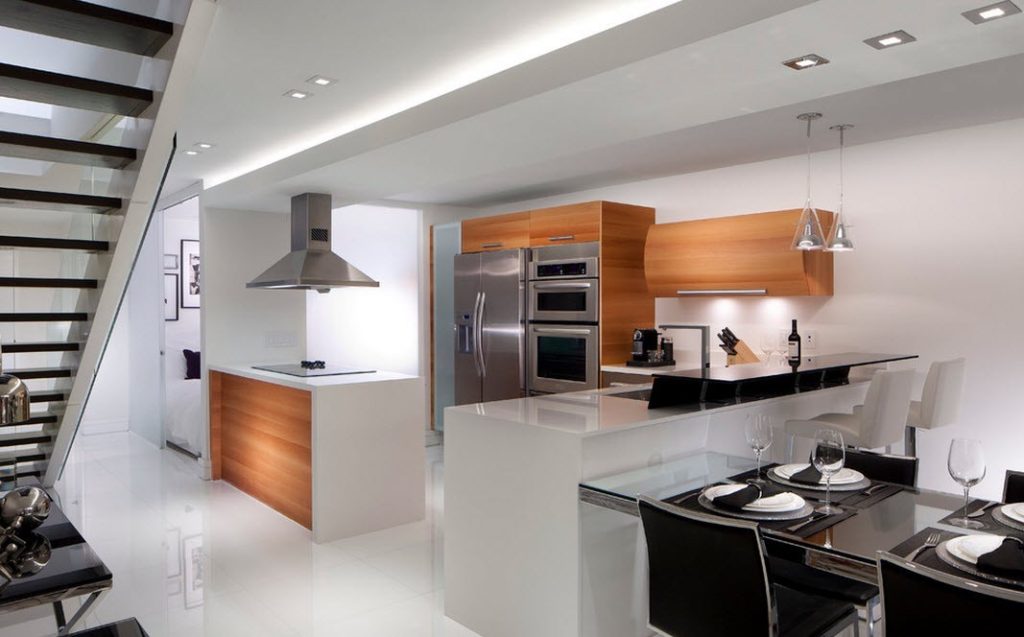 Brown kitchen cabinets with white walls