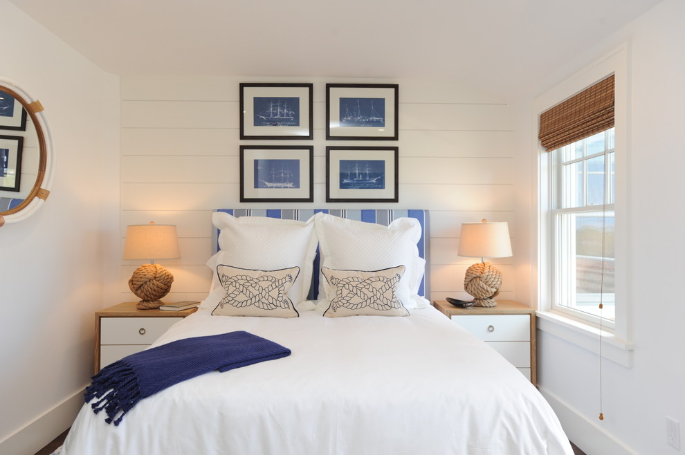 Paintings over the head of the bed in the white bedroom