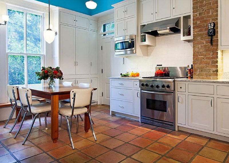 Cement grout in the seams of stone coating on the kitchen floor