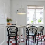 Red and white tiles on the floor of a modern kitchen