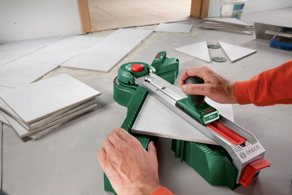 Trimming tiles before laying on the kitchen floor