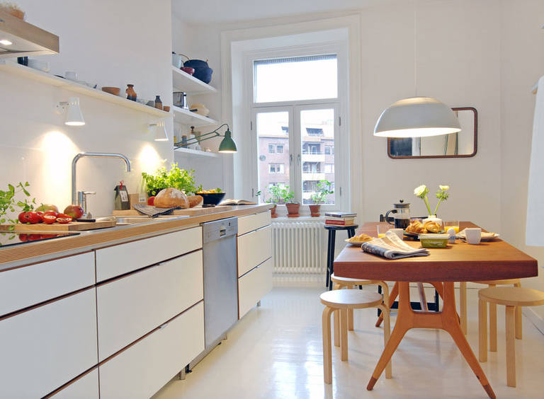 Wooden table in a white scandinavian style kitchen