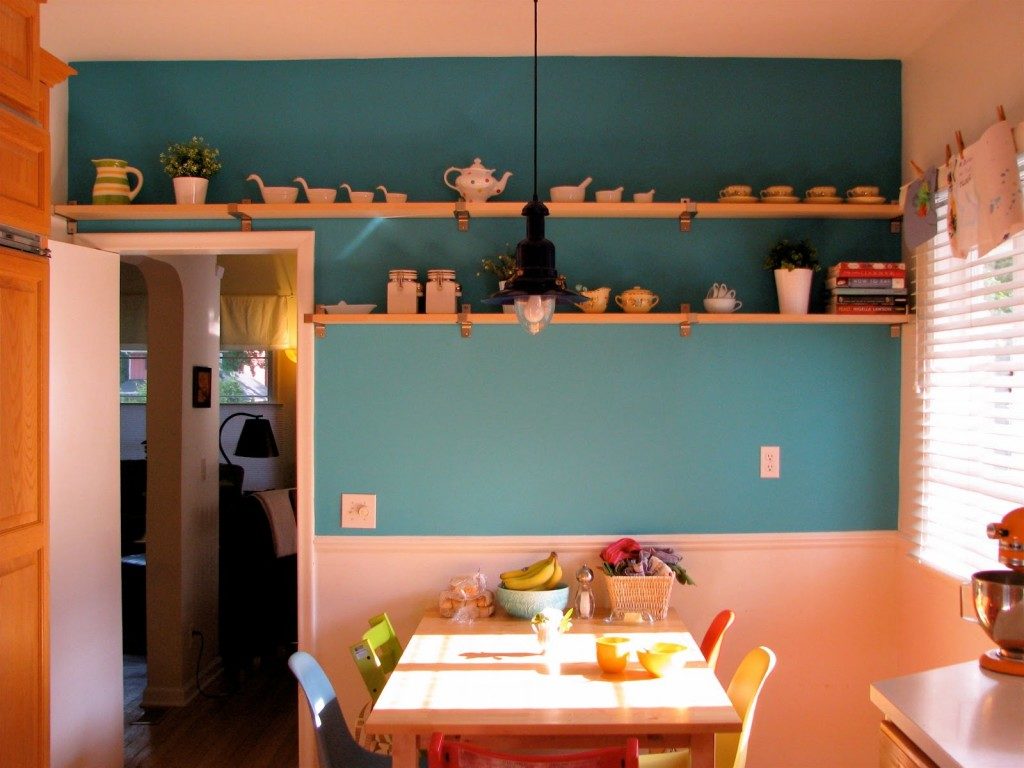 Cookware on wooden shelves.