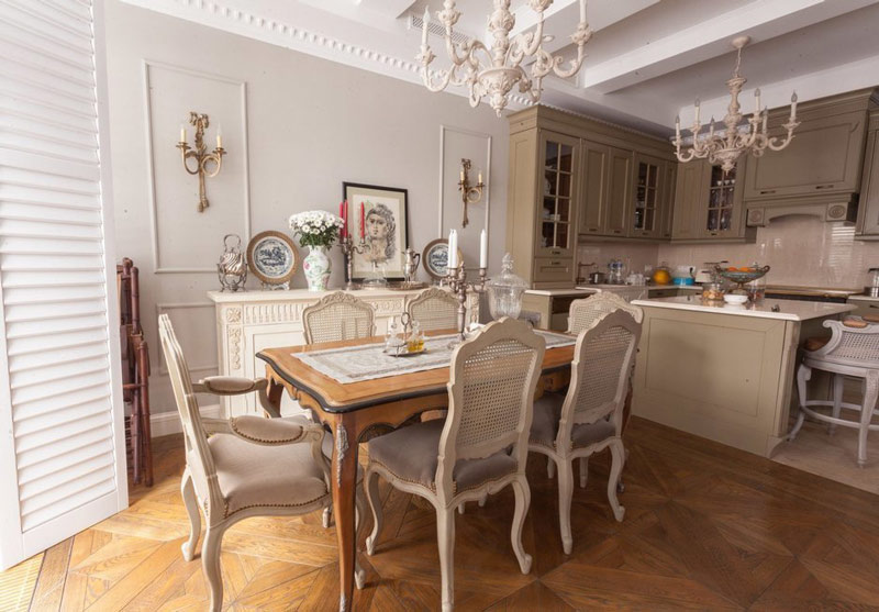 Two chandeliers on the ceiling of the kitchen-living room in a city apartment