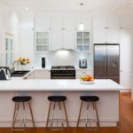 Black clock on a white kitchen wall