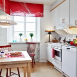 Red curtains on the windows of the kitchen