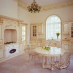 Dining area in the kitchen with high ceilings.