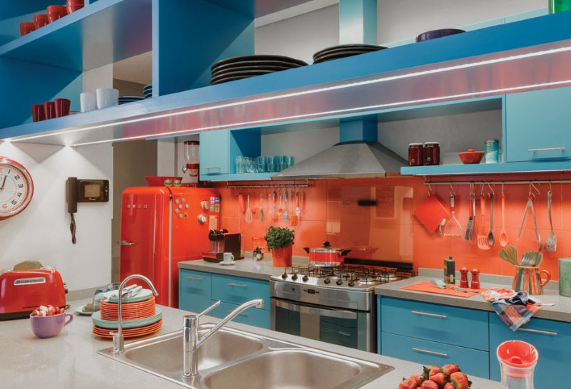 Red fridge in the kitchen with a pink apron