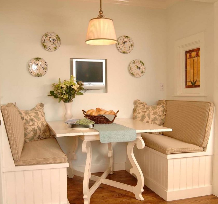 Two small sofas on the sides of the kitchen table