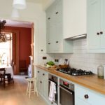 Single row kitchen with cupboards to the ceiling