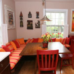 Orange pillows on the kitchen sofa