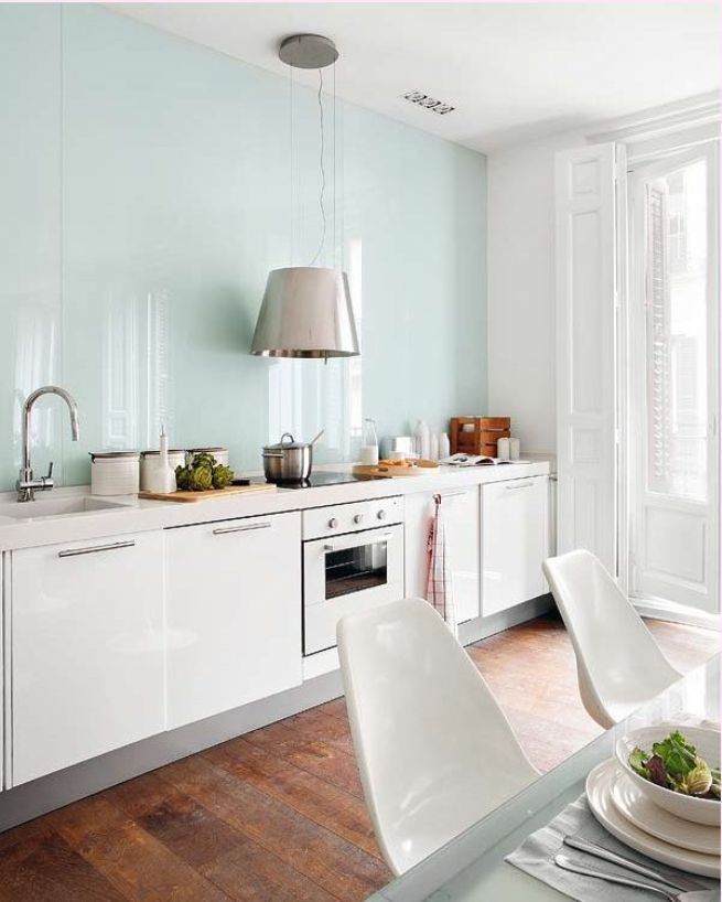 Bright kitchen with a glossy wall in blue