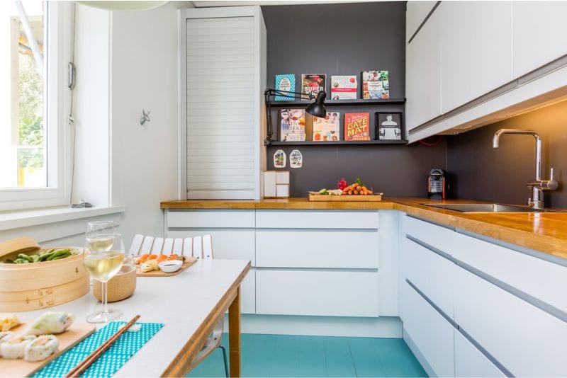 Blue floor in a small kitchen with wooden worktop