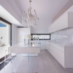 Glass chandelier in a white kitchen