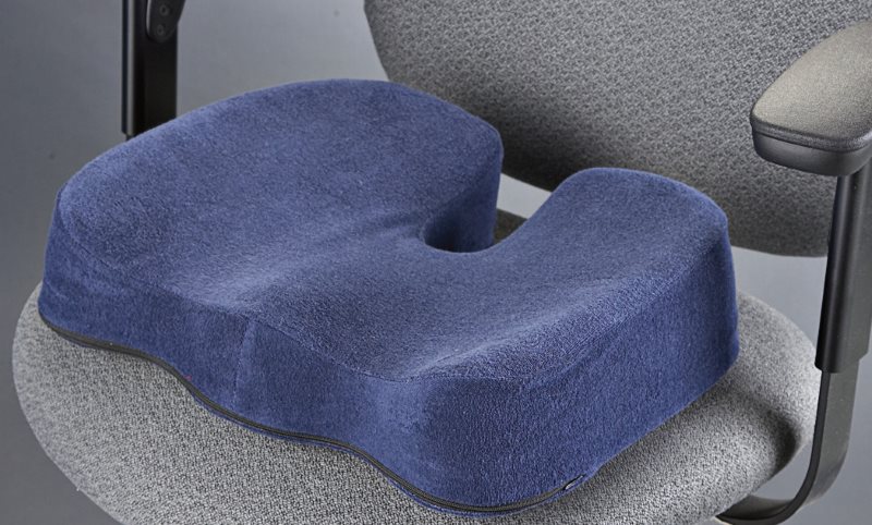 Navy orthopedic pillow on an office chair