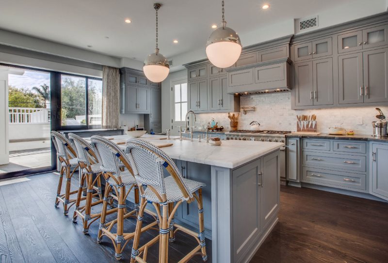 Wooden floor in the kitchen with a gray-blue set