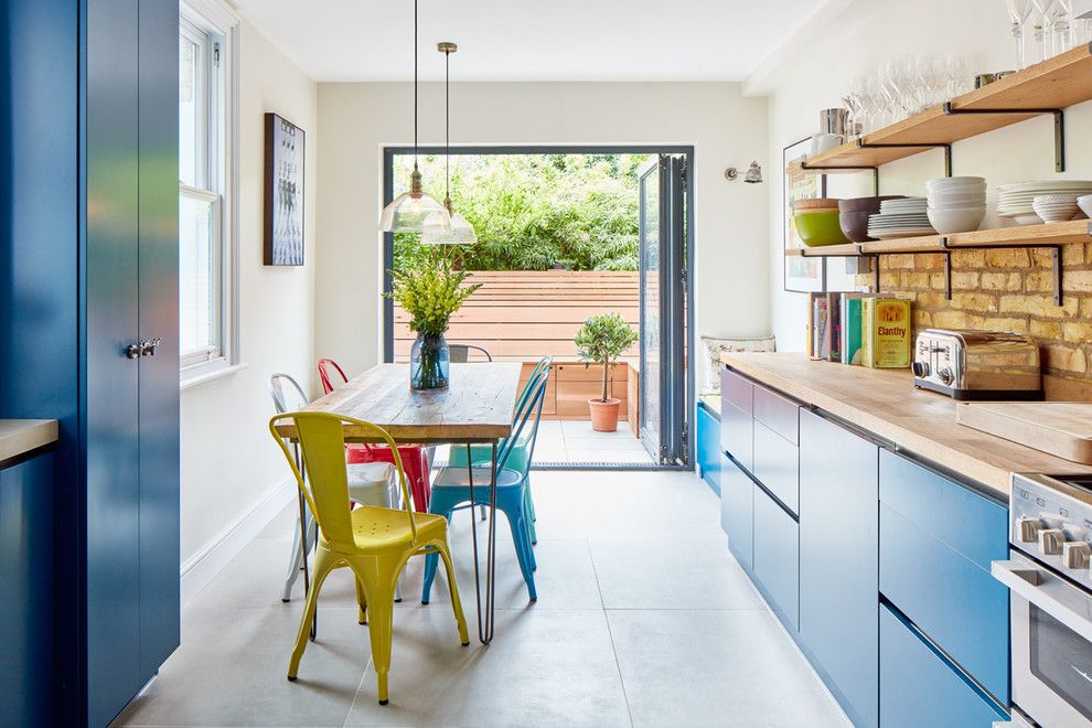 Blue kitchen with door to the patio of the cottage