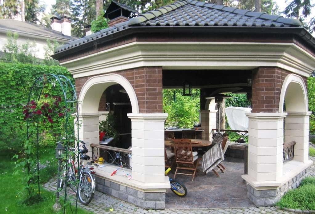 Brick pillars of summer kitchen with stone floor