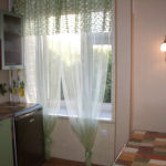 Green curtains on the kitchen window