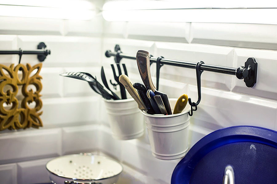 Buckets with kitchen appliances on a short railing