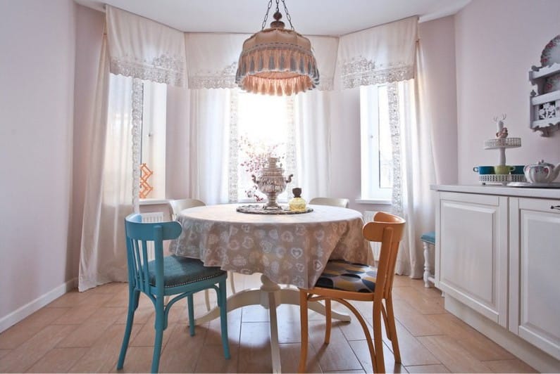 Beige tablecloth with a pattern on the kitchen table with a bay window