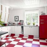 Red and white cage on a ceramic floor