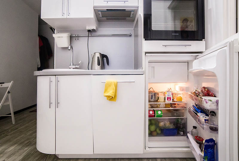 Small fridge at the bottom of the kitchen