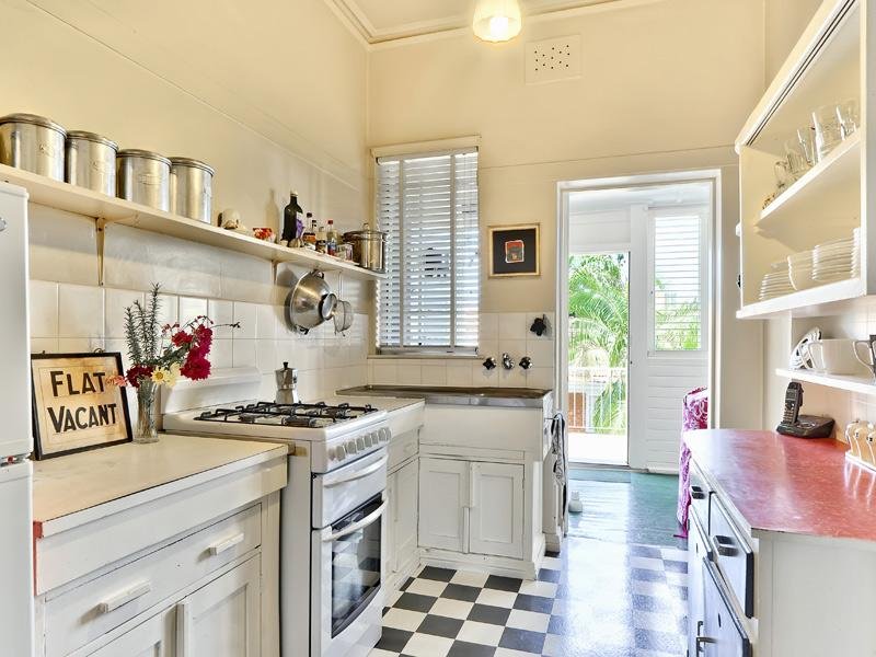 Black and white checkered floor in the kitchen of a private house