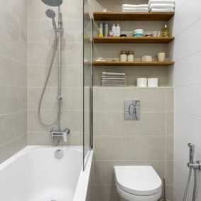 Wooden shelves above a hanging toilet