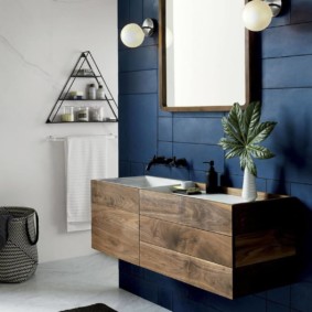 Wooden cabinet in the bathroom with blue walls