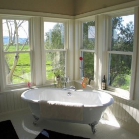 Baignoire dans une pièce aux fenêtres en bois