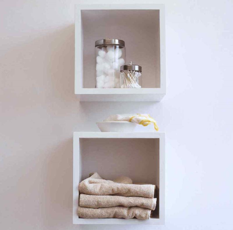 Chipboard-based square shelves on the bathroom wall