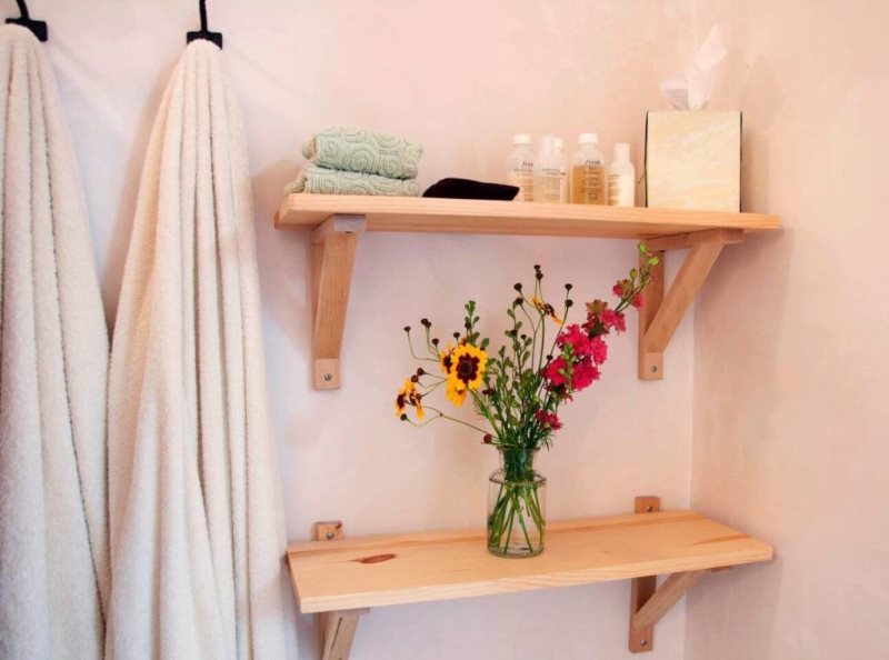 Simple wooden shelves on a pink wall